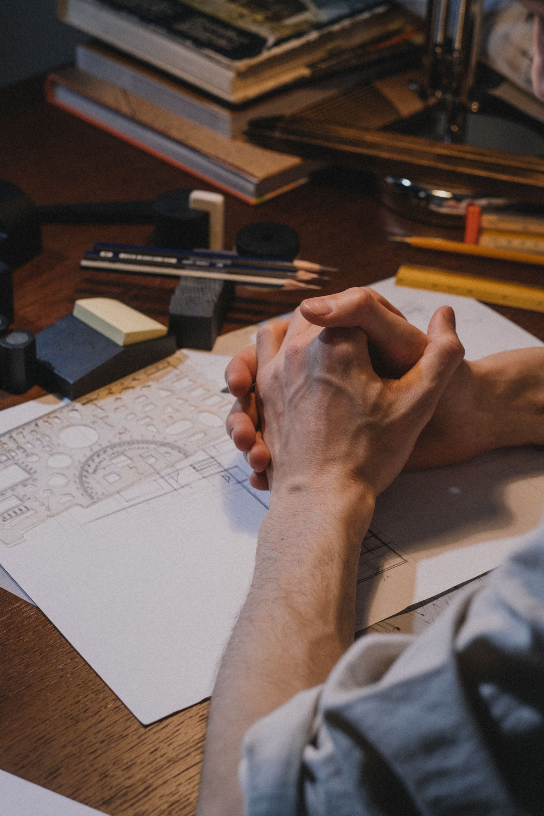 Designer drawing by hand at a worktable